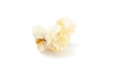 Piece of popcorn isolated on blank background, close up