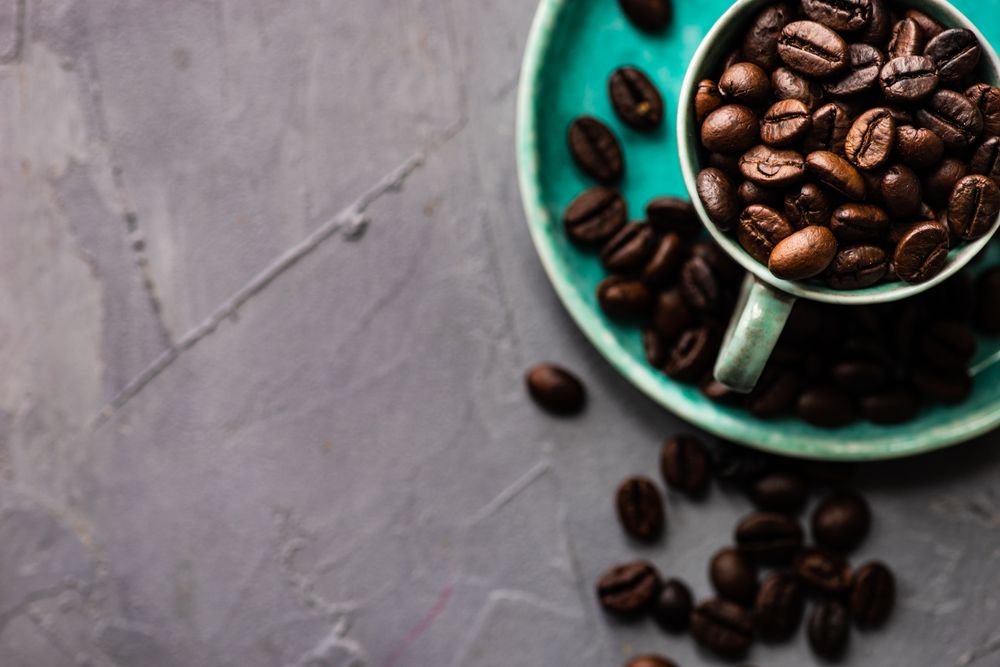 Teal cup with coffee beans