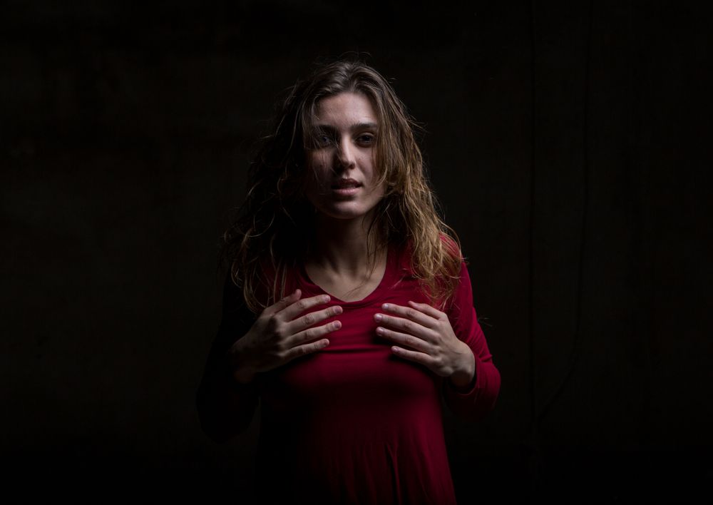 Young woman dancing in darkness