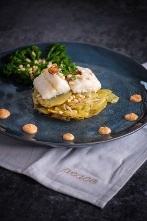 Delicious gratin with fish and sauce with broccoli
