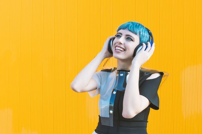 Cool informal woman in headphones on street