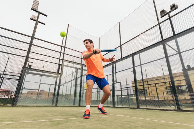 Man playing paddle tennis. backhand