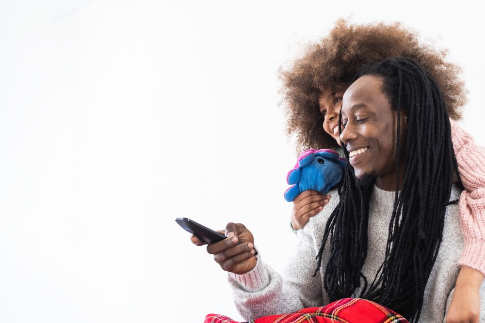 Cheerful Black dad and daughter enjoying free time together