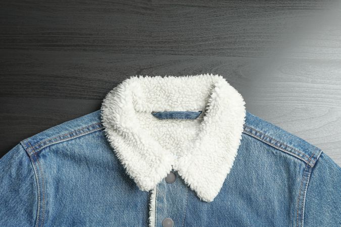 Denim jacket on background, space for text