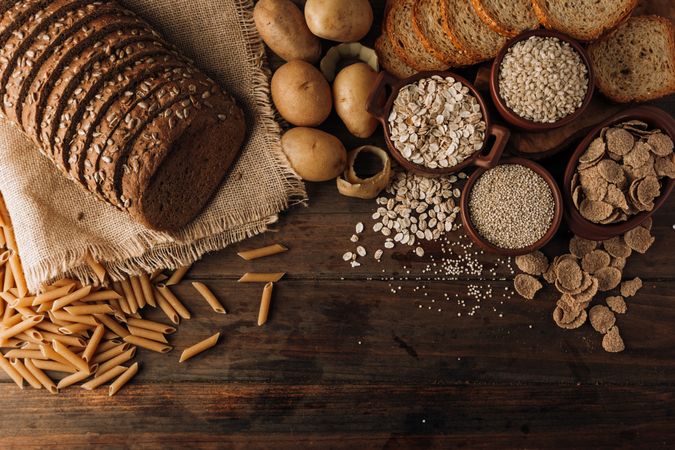 Wholegrain food and freshly baked rye bread on table