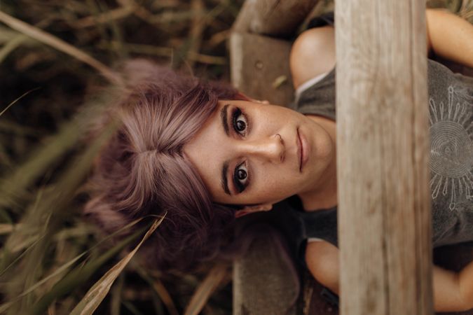 Woman lying on wood pier