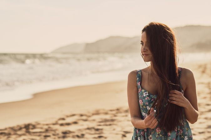 Young woman in the beach at sunset