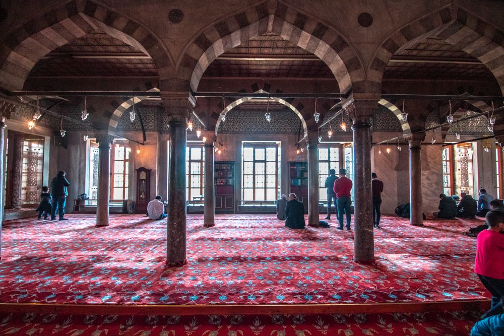 Back view of men praying at the mosque