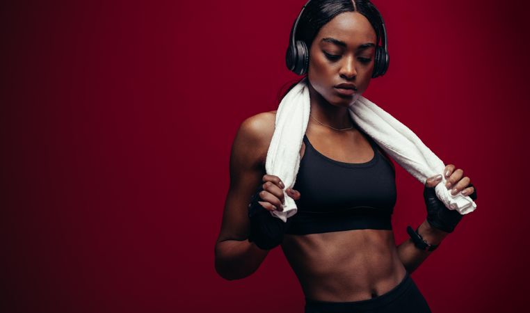 Black female athlete listening music after workout