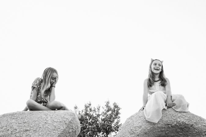 Charming little girls on rocks