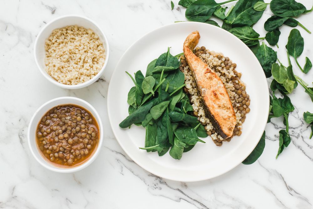 Served salmon steak with beans and couscous