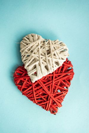 Thatched hearts on blue pastel table