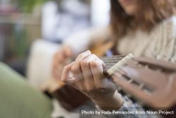 Close up of female hand on fretboard of guitar 4ONWg5
