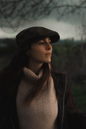 Young woman in warm clothes in forest
