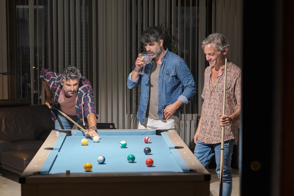 Group of men playing pool together