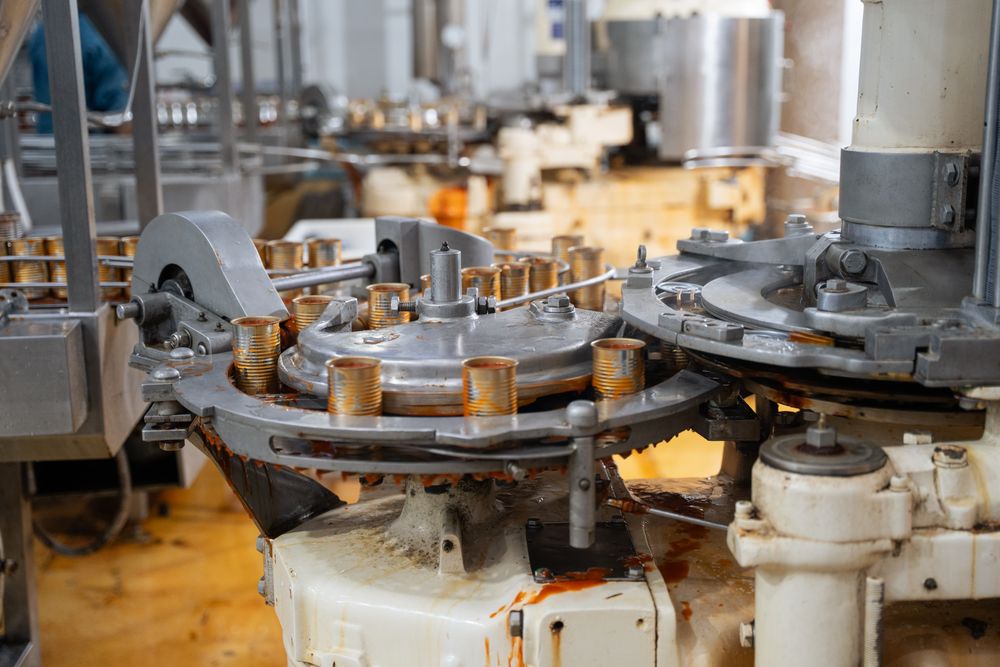 Background of canned food on conveyor belt in fish factory.