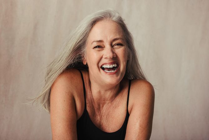 Grey haired woman celebrating her body
