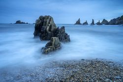Misty landscape of Playa de Gueirua rock beach