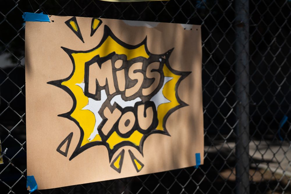 Close up shot of handmade sign with the words “Miss you”