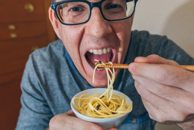 Man eating spaghetti and crickets