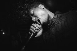 Close-up of young man singing into microphone