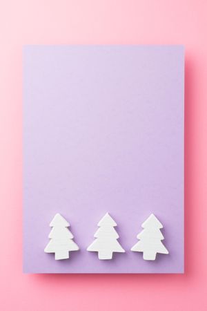 Light pine trees on purple and pink background