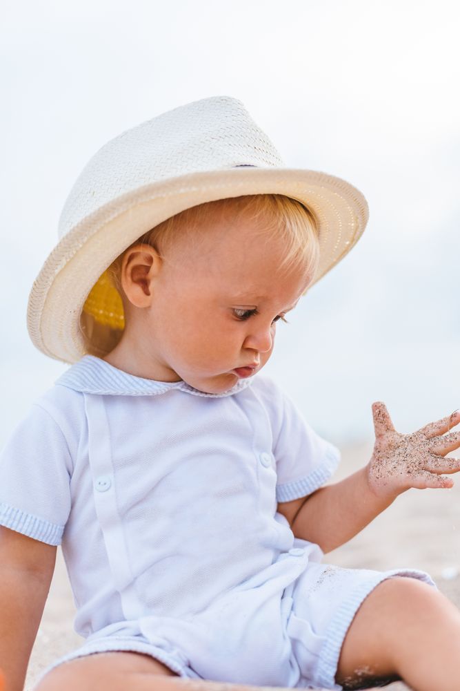 Baby on the beach with hat