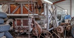 Vintage harvester farm equipment in shack