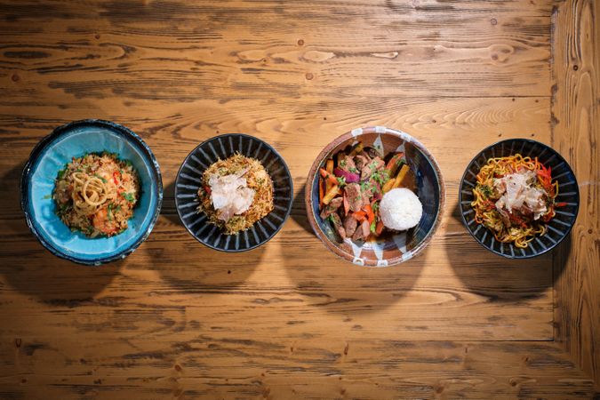 Appetizing dishes served in bowls on wooden table
