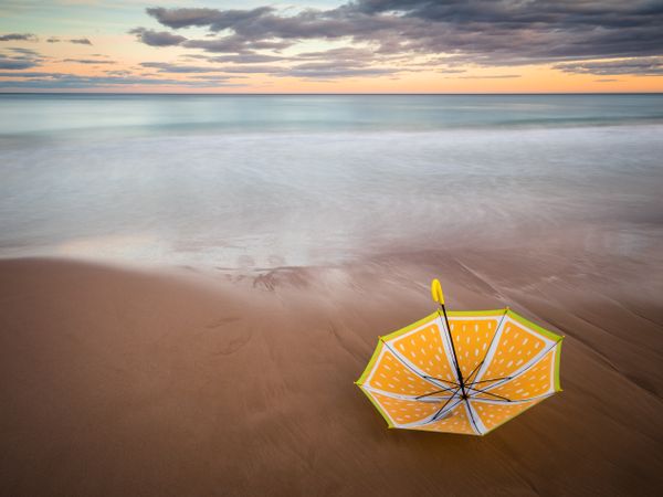 Umbrella on beach near sea