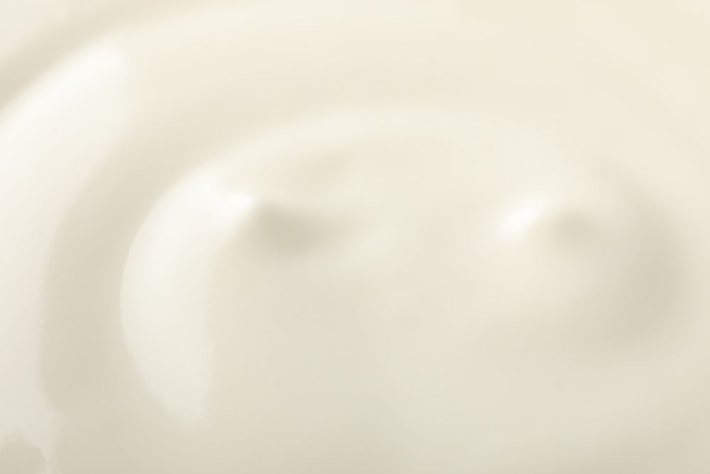 Cream yogurt as background, closeup and space for text