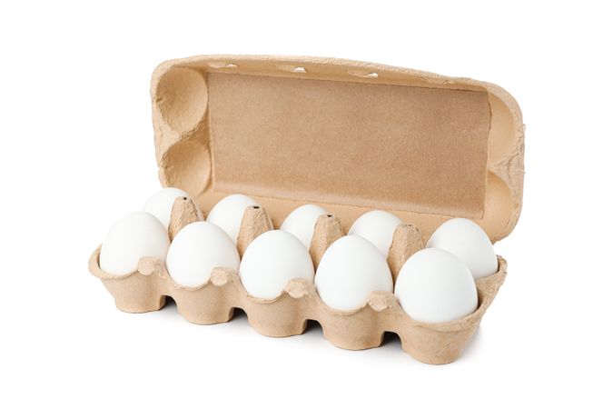 chicken eggs in carton box isolated on blank background