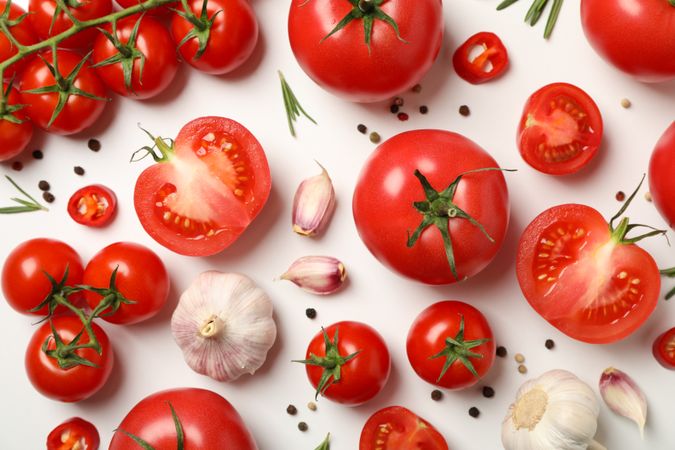 Composition with tomatoes and ingredients on light background, top view
