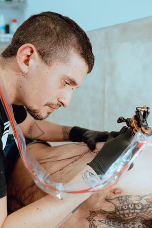 Stylish man drawing tattoo
