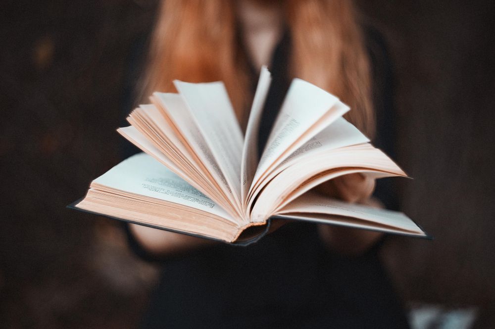 Close-up shot of woman holding an open book