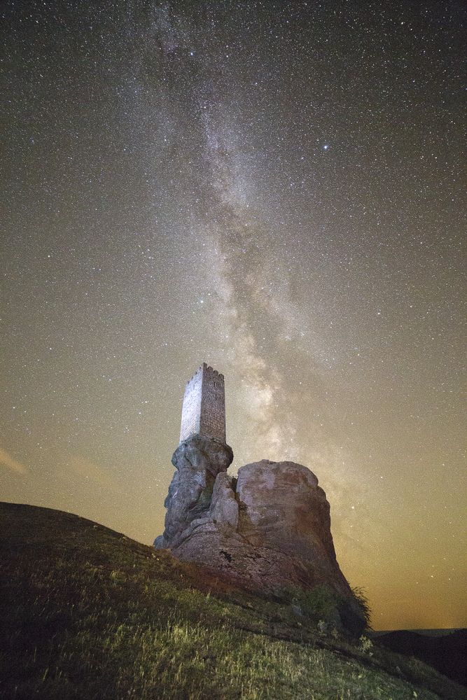 Ancient fort on rock in starry night