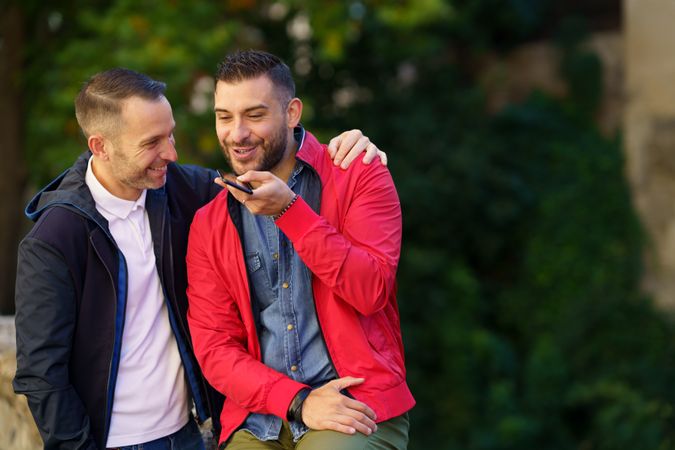 Cute male couple speaking on phone