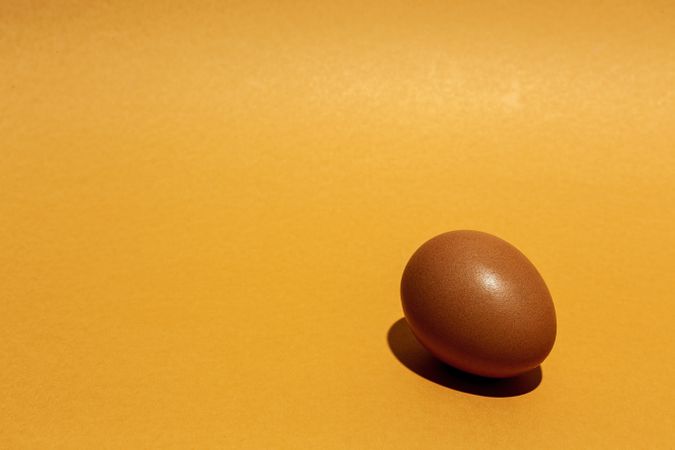 Fresh raw eggs on brown background