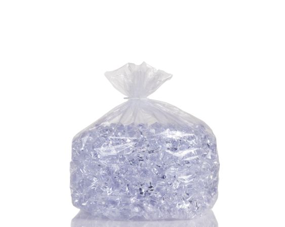 Clear plastic bag filled with ice cubes isolated on plain background