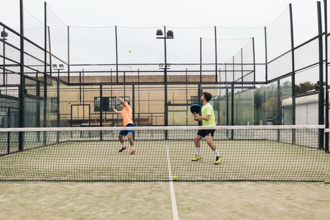 Two young man playing paddle tennis