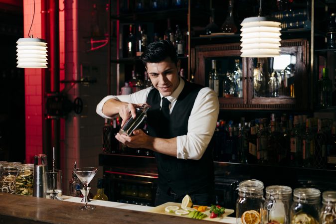 Barman working mixing drinks in a shaker