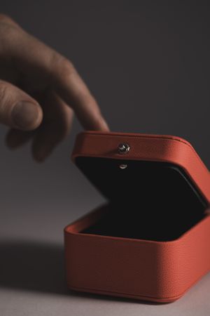 Hand reaching red jewelry gift box