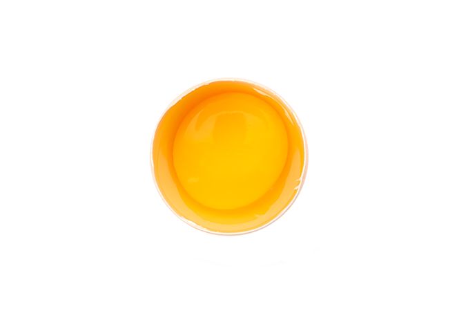Half broken egg with yolk isolated on blank background, top view