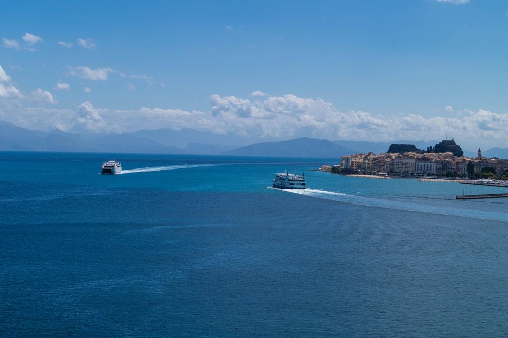 Boats on blue sea under blue sky