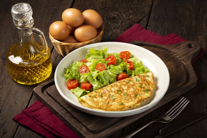 Omelet with cheese and lettuce and tomato salad.