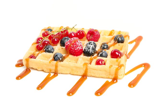 Waffle under caramel topping isolated on blank background