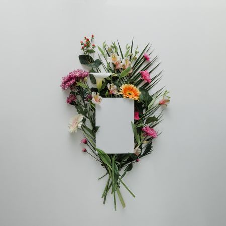 Flower bouquet on light background with paper card