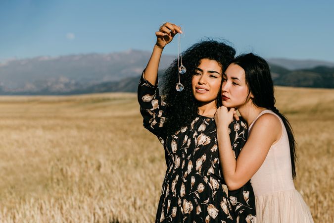Female friends standing in field