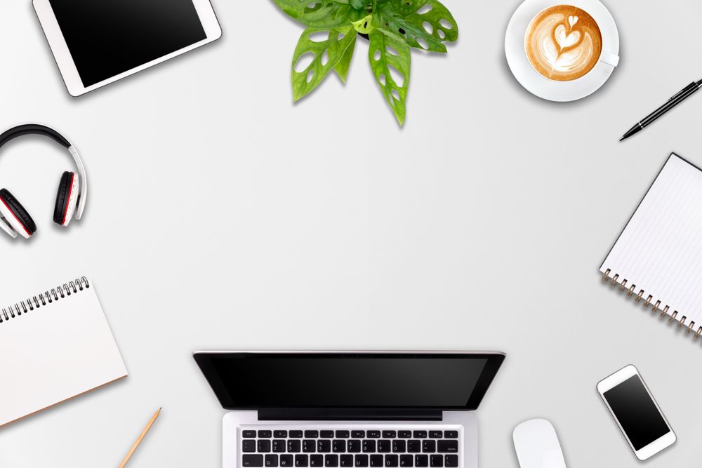 Modern workspace with laptop tablet, smartphone and coffee cup copy space on color background
