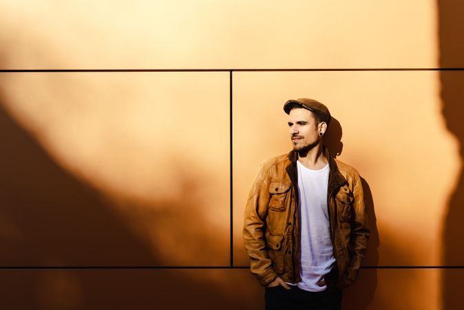 Confident guy leaning on wall